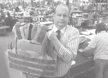 Don Budke holds up an armoured vest, on Wednesday, 17 March, 2004, at Reliance Armour Systems, Inc, in Cincinnati where the vest is made.
