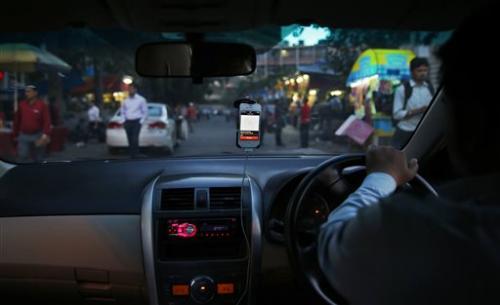 Uber meets local lookalikes in Asia taxi-app wars 14 April 2014, by Kay Johnson In this Wednesday, March 19, 2014 photo, an Uber taxi driver drives his car through a street in New Delhi, India.