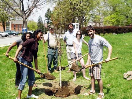 Page 8 Favorite Photo Biology students Anakai Smith, Ester Okeke, Fiona Brabazon, and Zachary Hernandez plant a tree (Oxydendron arboreum Sourwood or Lily of the Valley) near the Communication