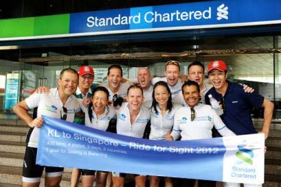 Photo C Standard Chartered employees in front of the