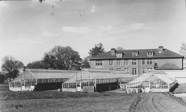 French Hall Greenhouse with French Hall in background, view west, (early to mid20 th century) Courtesy