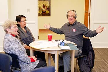 Above: John Koehn, of WLEN Radio, interviews Sister Carleen Maly (left) and Julia, an adult learner. Giving Lives Back: St.
