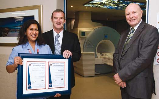 Sharon Coutinho (left) from Fremantle Hospital s Radiology Unit receives the RANZCR/NATA acccreditation certificate from Parliamentary Secretary to the Minister for Health John Hyde, and NATA CE Alan