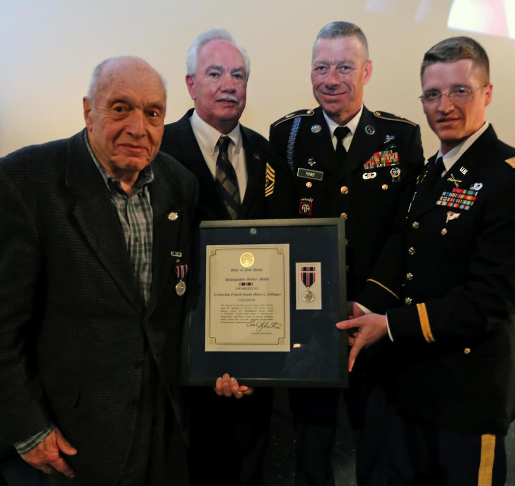 Photo right, Harry Ettlinger, left, poses for a group photo with Ray Zawacki, center left, deputy commissioner of veterans affairs, 1st Sgt.