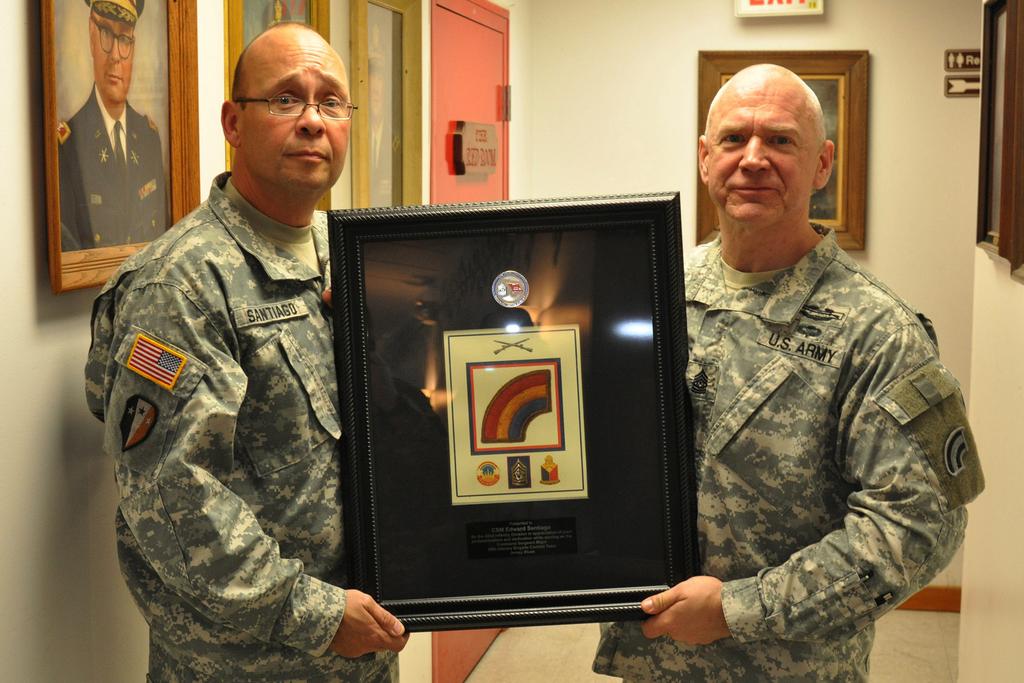 Westhoven / Released) Page 4 Command Sgt. Maj. Edward Santiago, 50th Infantry Brigade Combat Team, New Jersey National Guard, receives a framed 42nd Infantry Division patch from Command Sgt.