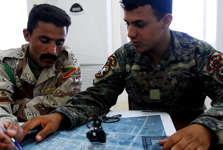 Two Iraqi Army Soldiers review points on a map during a commando training exercise