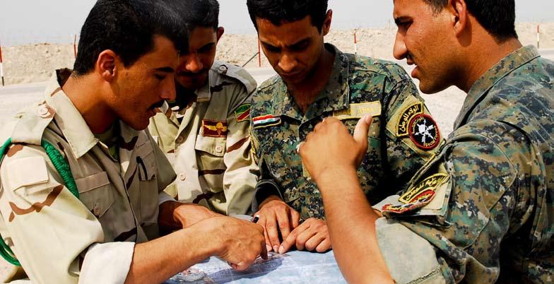 A group of Iraqi Army Soldiers plot their route on a map during a commando training