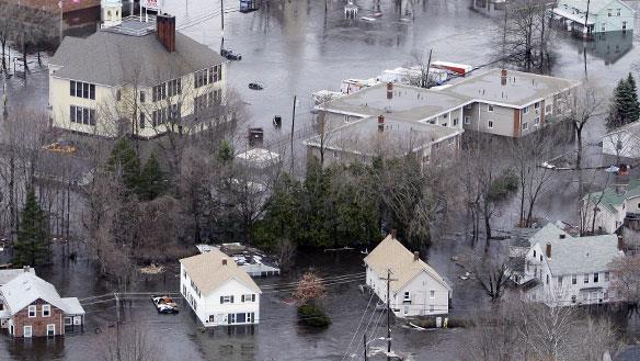 Water from the Pawtuxet River encircles homes in West Warwick, R.I., on Wednesday.