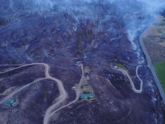 2. Aerial view of the wildfire showing terrain used in dozer line construction and state highway. Credit: King5 News website.