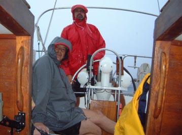 Neither dead wind, nor rain shuts down Roi Regatta By Ed Harris Kwajalein Yacht Club Opus captain Hal Dunn and Dan Fogarty