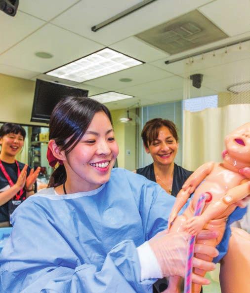 B E L O W : Yoko Inada (cener), visiing Rugers School of Nursing wih a nurse midwifery sudy