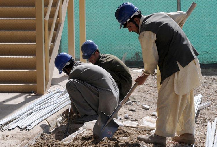 ECONOMIC $TRATEGY Regional Contracting Centers work to boost economy (U.S. Army photo by Sgt. Matthew Nedved) Afghan citizens work on a construction site Oct.