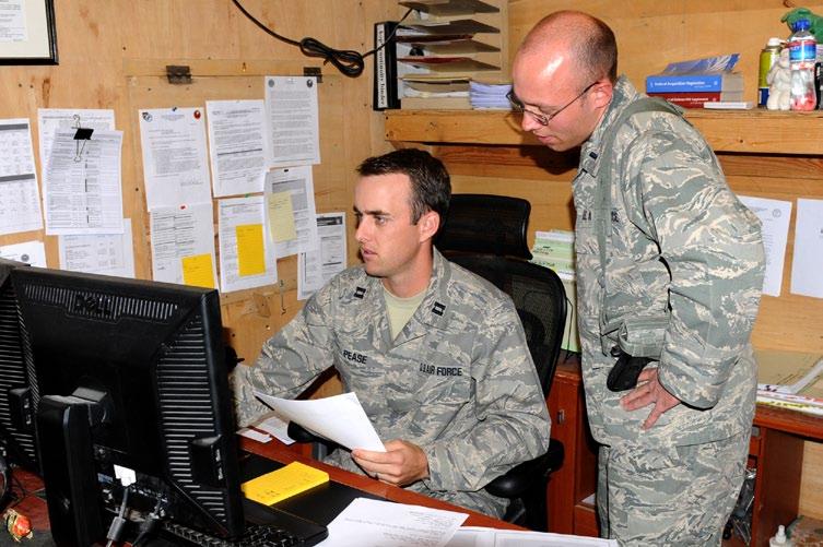 (U.S. Army photo by Sgt. Matthew Nedved) U.S. Air Force Capt. Casey Pease and 1st Lt. Elijah Horner, Phoenix Regional Contracting Center (PRCC), review a contract Oct.