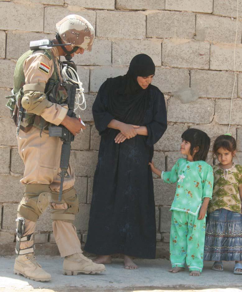 A soldier with 2nd Battalion, 31st Brigade, 8th Iraqi Army Division talks with villagers during Operation Gunslinger Bonzai III, a mission