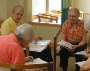 Marie Narlock and Rosalie Noder discussed topics. A group discussion (below center) with Sisters Joan Theiss (center), Kathy Sadler (right) and William McCue.