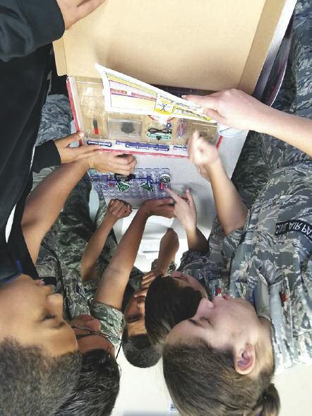 Cadets from the Puerto Rico Wing work on Snaptricity, a Civil Air Patrol STEM Kit that teaches how electricity and magnetism are generated.