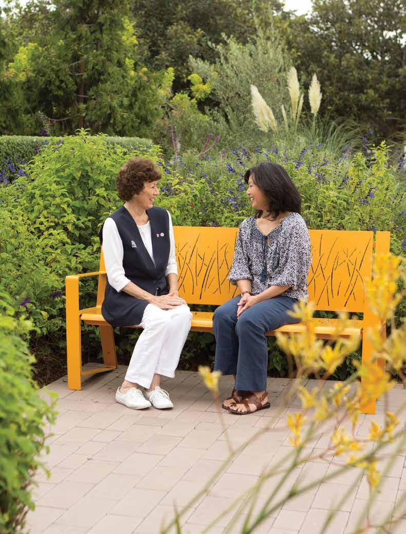 03-04 OUR CAMPAIGN TO LEAD, INNOVATE & TRANSFORM A Hoag Auxiliary volunteer visits with a guest in the garden at Hoag Hospital Irvine.