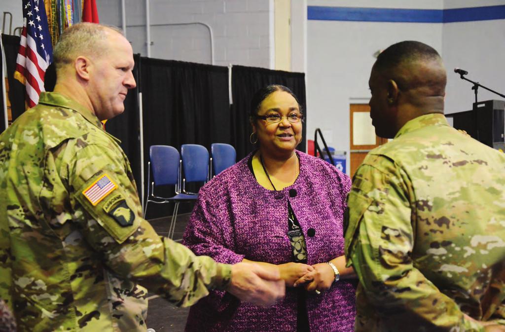 NEWS Photos by DEMETRIA MOSLEY Education Services Officer Veronica Fields-Cox listens as Fort Jackson Commander Maj. Gen. John Pete Johnson, left, and Command Sgt. Maj. Lamont Christian, right, discuss Tuesday s college and career fair.