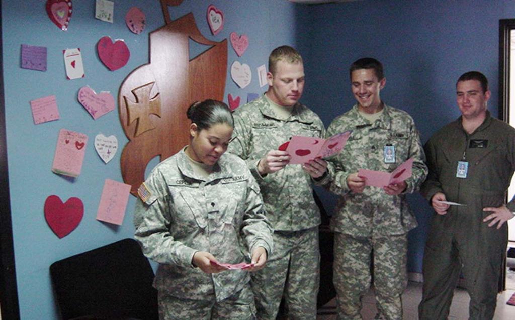 Parting Shot Specialists Jennifer Cepeda and Kevin Fitzsimmons, Sergeant Dale Coyle, and Specialist Stanford Neal enjoy reading the Valentines sent to them from elementary students in Oklahoma.