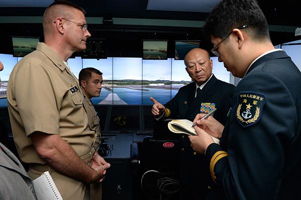 Capt. Dave Welch, commanding officer of Surface Warfare Officers School, gives a tour of the school to Commander