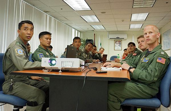 and Philippine pilots and aircrewmen participate in an aviation symposium during Cooperation Afloat Readiness and