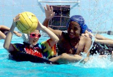 U.S. Army Kwajalein Atoll, Republic of the Marshall Islands By KW Hillis Summer Fun makes a splash Alyssa Reynolds does her best to keep the ball away from Carlos Notarianni during a spirited and wet
