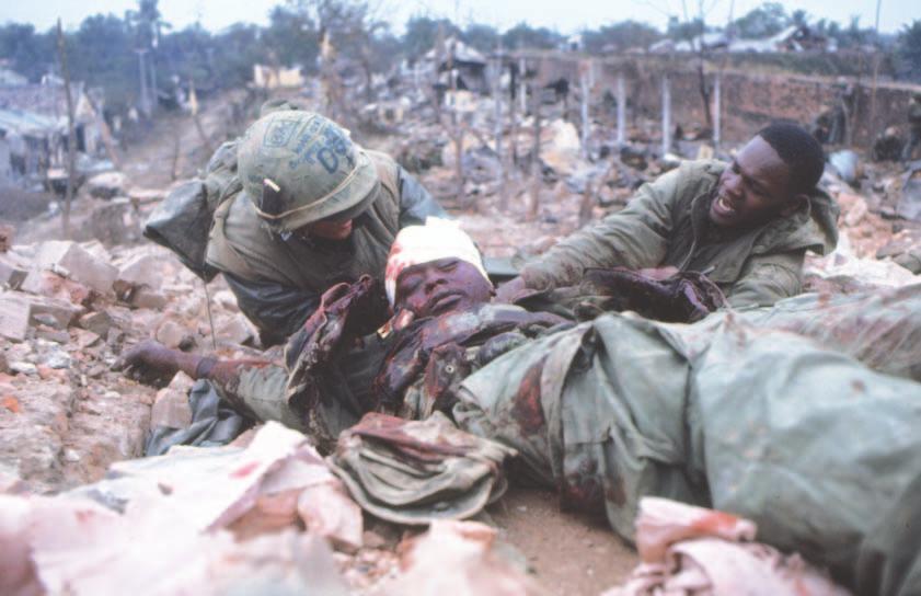 PAGE 14 F3HIJKLM STARS AND STRIPES Tuesday, January 30, 2018 PHOTOS BY JOHN OLSON/Stars and Stripes Two U.S. Marines try to help a Marine who was severely wounded in the battle for the tower guarding the Eastern Gate of the walled citadel in Hue, Vietnam, on Feb.