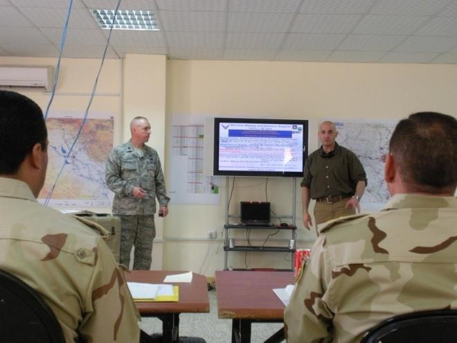 Left to Right: Lt Col Jeff Coggin & Mr. Mathus Remaden (Linguist) teaching the Decision Support Workshop, 18 21 July 2009 at Camp Victory, Iraq.