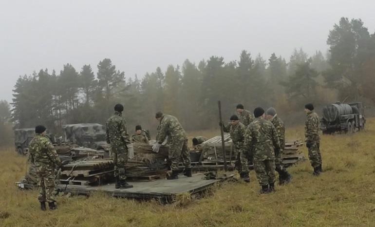 Soldiers from 74 th CSS Company (Czech Republic) prepare to conduct resupply-on-the-move operations during a rotation at JMRC.