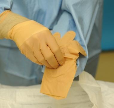 hand. Peel the cuff of the glove over the dominant cuffed hand, over the end of the sleeve.