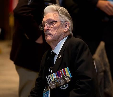 Veteran Desmond Vinton, the president of the New Zealand Korean War Veterans Association, ponders remarks made by the emcee during the Korean cultural program at the Grand Ambassador Hotel, or his