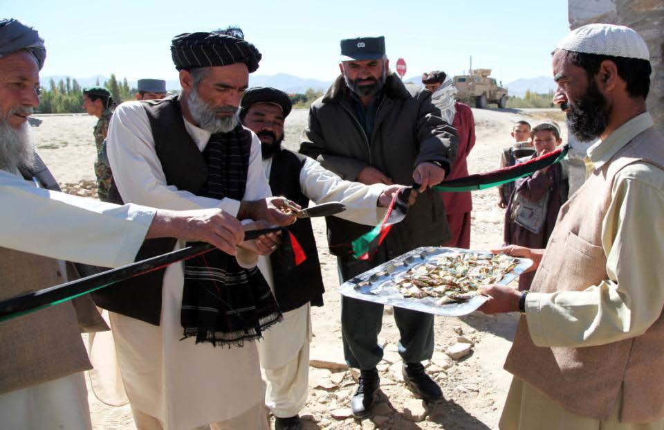 Afghan leaders cut a ribbon in celebration of the opening of Khalid Bin Walid Takya High School in