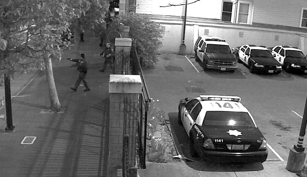 Image 6: SFPD sergeants pursuing Hoffman into the street with guns drawn (Source: SFPD Security Video) Once outside the parking lot, Sergeant Johnson deployed his OC canister (i.e., pepper spray) directly into Hoffman s face with no effect.