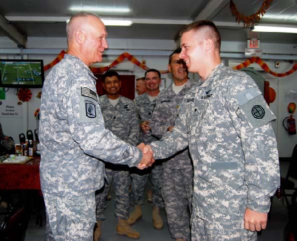Schulte awards SPC Taylor Rhodelander his coin for outstanding performance as a Production Control Specialist and an AH-64 Apache Mechanic.