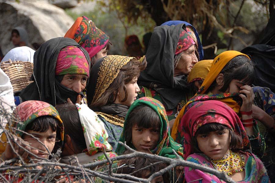 Women and children gather in anticipation for a humanitarian aid handout in the Wagel valley, Afghanistan, Nov. 02, 2009.