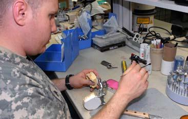 , 44th Med. Cmd., MND-B, works to build up a Soldier s dental core in preparation for a crown. make up the basic issue.