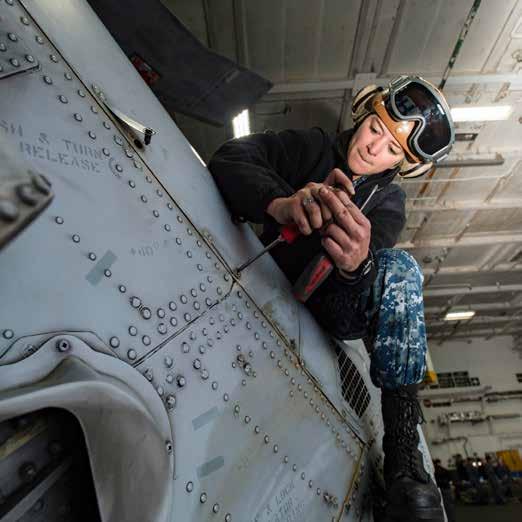 An Airman reattaches fasteners on the tail rotor of an MH-60R Sea Hawk helicopter. (U.S. Navy photo by Mass Communication Specialist 2nd Class Andrew J.