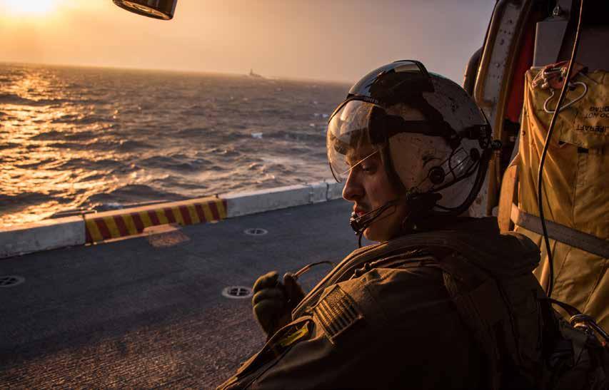 A Naval Aircrewman makes preparations to take off in an MH-60S Sea Hawk helicopter. (U.S. Navy photo by Mass Communication Specialist 2nd Class Sean M.