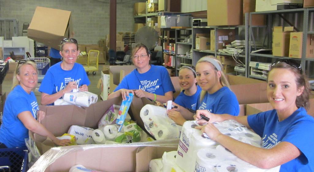 COVER STORY Left: Employees from South Central Kansas Education Service Center and their family members volunteered at United Way s GIV Warehouse last summer.