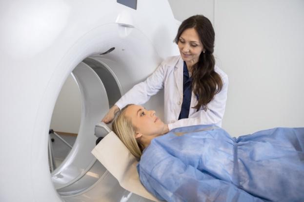 During radiation therapy you lie down on a treatment table and a large machine moves around you and aims a beam of radiation at the cancer.