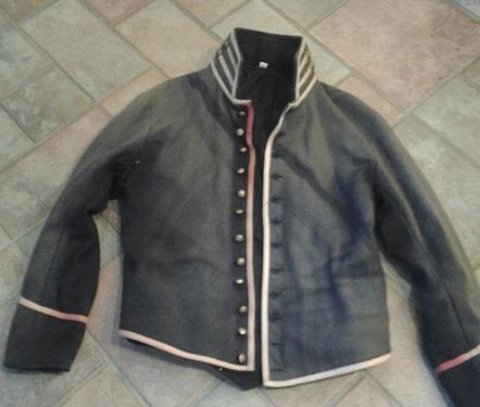 An 1884 Advertisement Civil War US Artillery Shell Jacket, dark blue with the red piping (extremely faded), says size 40 (I am sure it