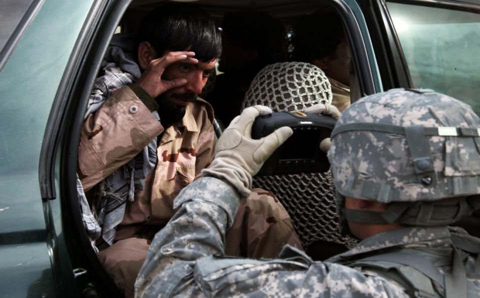 A soldier from 2nd Platoon, A Company, 1-503rd Infantry Battalion, 173rd Airborne Brigade Combat Team enters a member of a private Afghan security company into the Biometrics Automated Toolset (BAT)