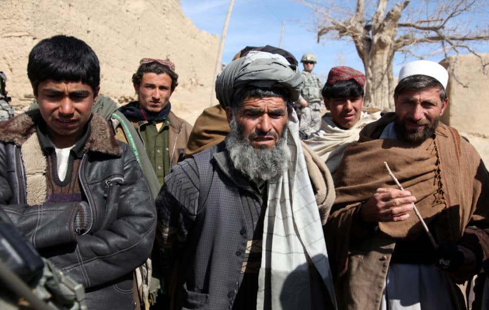 Afghans talk to a patrol of U.S. Army soldiers in the village of Bar Mamel, Wardak Province, Afghanistan, Feb.19, 2010.