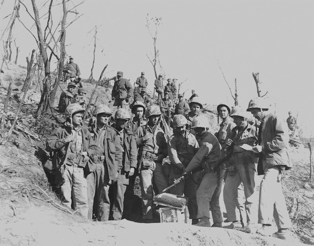 1951 Korea MARINES IN KOREA CELEBRATE CORPS' 176TH BIRTHDAY--On a shell-scarred ridge in eastern Korea, battleweary veterans of the First Marine Division take time out to cut the cake celebrating