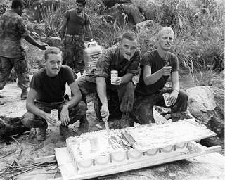 1969 Vietnam 1st Lt Raymond Horn, CO C/1/7, cuts a piece of cake to celebrate the