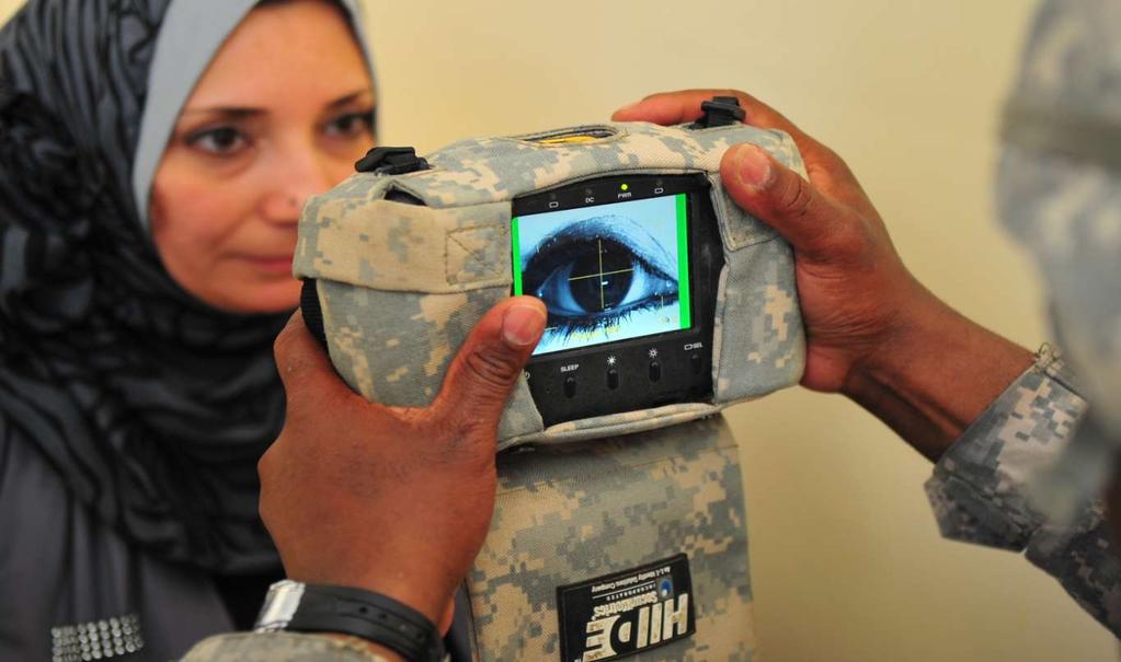 A women is screened by a Hand-held Interagency Identity Detection Equipment (HIIDE) in Mosul Province, Iraq, October 1, 2010.