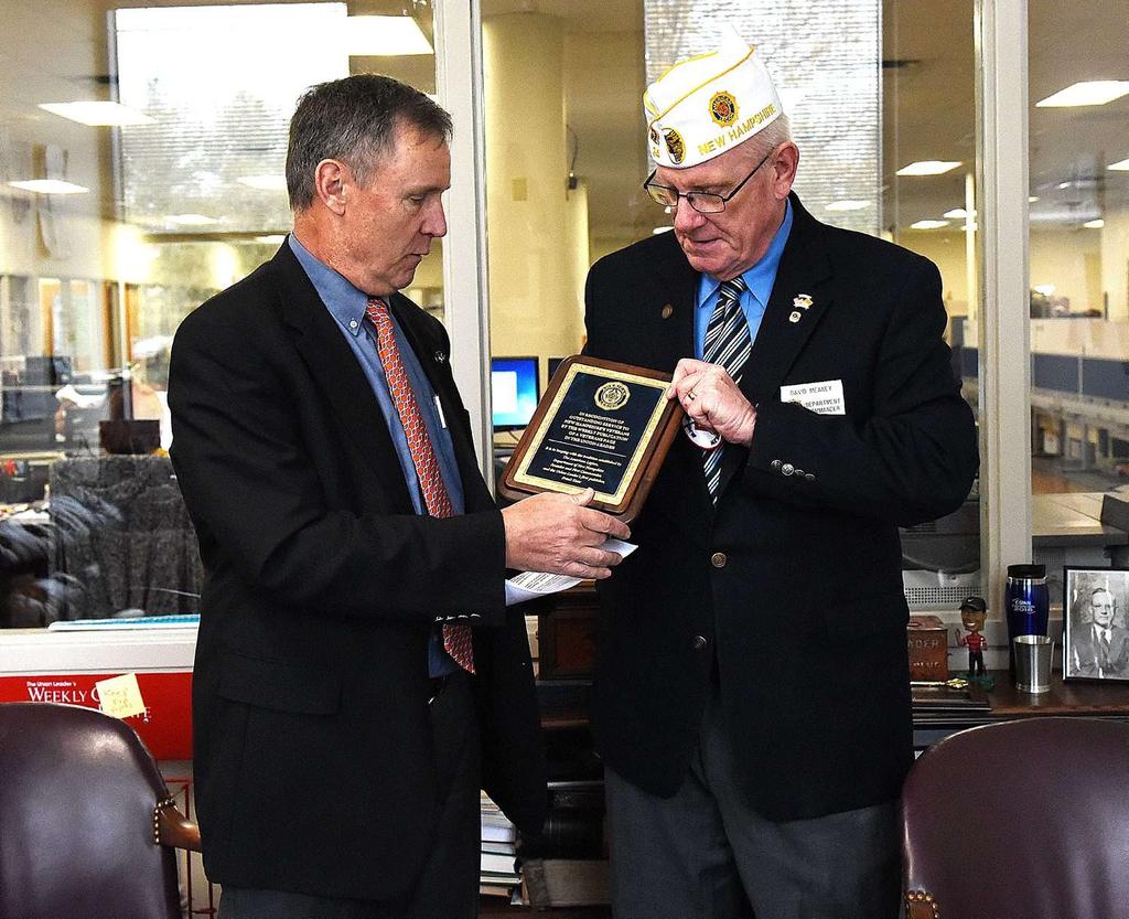 American Legion Department of New Hampshire Commander Dave Meaney presents a plaque to New Hampshire Union Leader Publisher Joseph W.