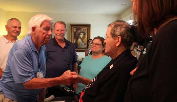 Veteran and NorthBay Hospice & Bereavement volunteer Mike McGee (at left) shakes hands with Vernon Spridgen following the military pinning and presentation ceremony at his Vacaville home.
