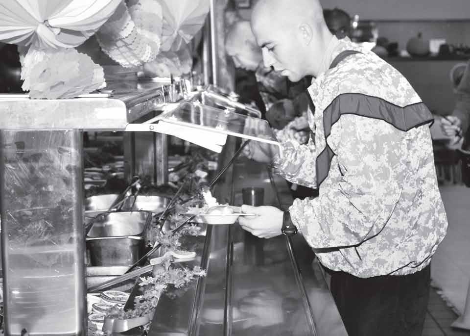 News A Soldier with the 120th Adjutant General Battalion (Reception) fills up his plate with turkey and fixings.