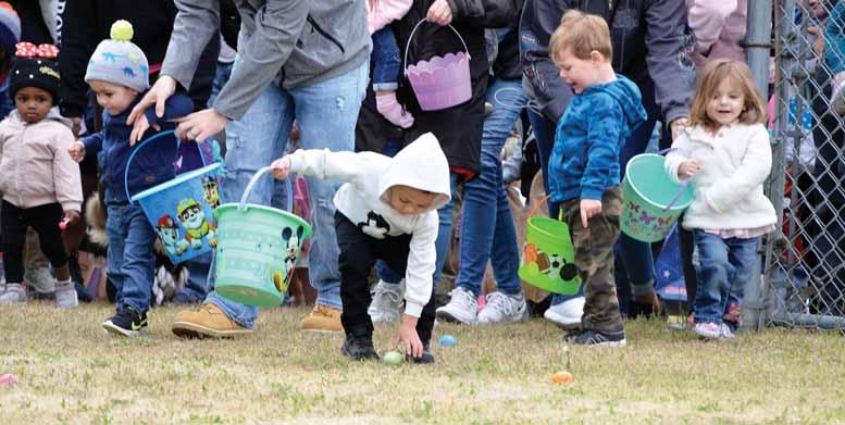 Photos by LATRICE LANGSTON Children ages two and under storm the Youth Services Complex activity field to collect prize and treat filled eggs at the annual Spring Jamboree and Egg Hunt hosted by
